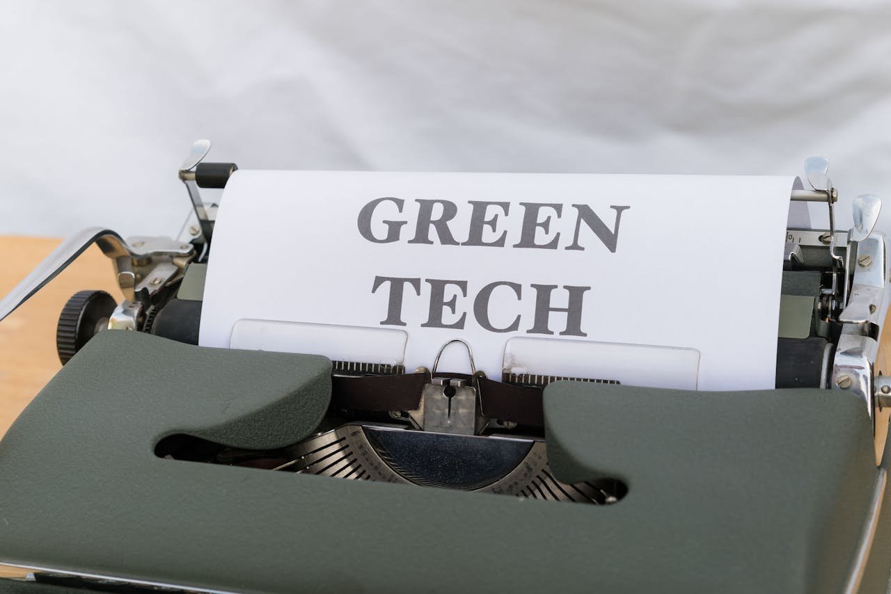 Vintage typewriter displaying the text Green Tech, symbolizing eco-friendly innovations.